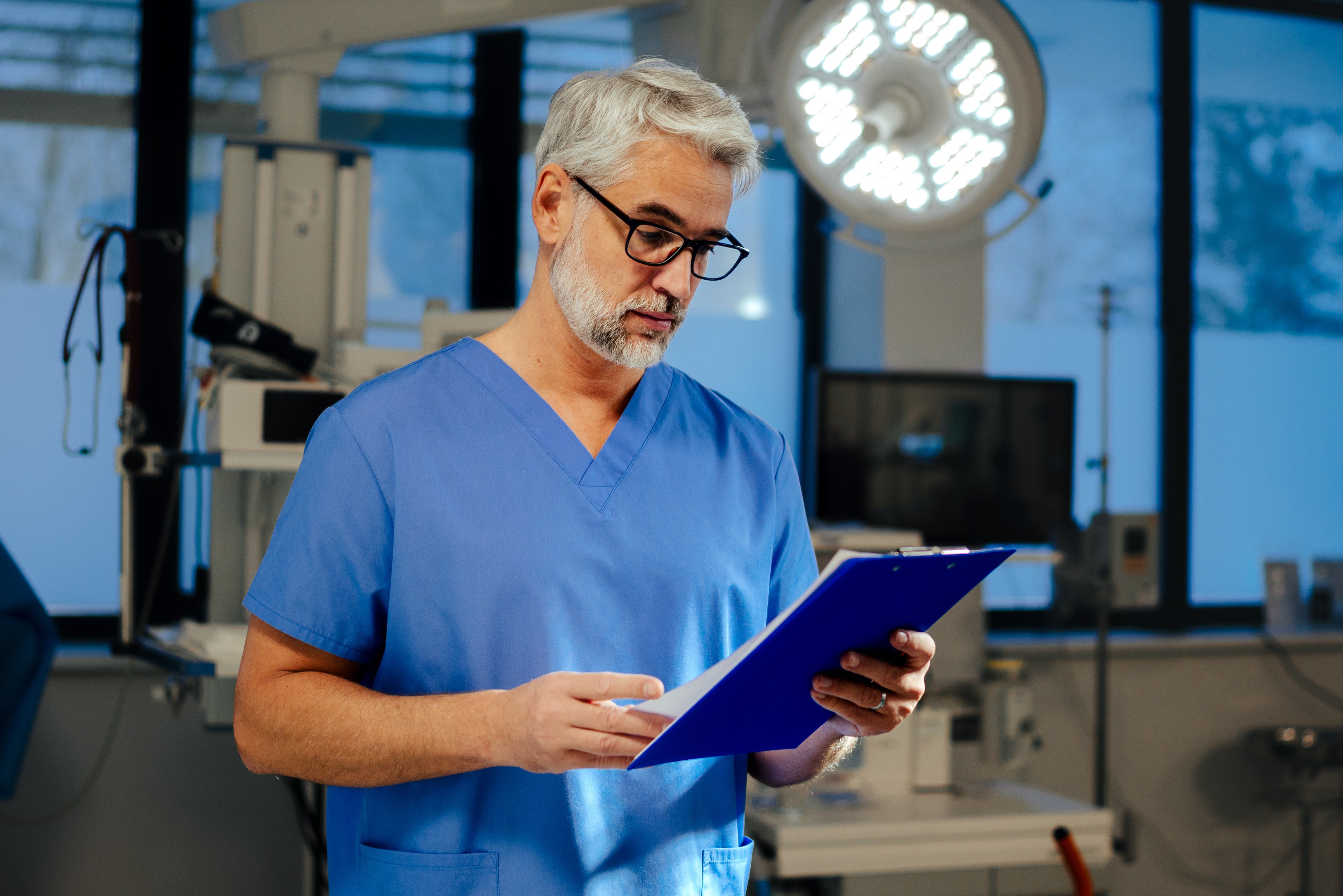 Surgeon reviewing a treatment plan prior to operating